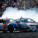 That’s Deane hanging on reigning American champion Chris Forsberg’s door. Photo Credit: Larry Chen/Formula Drift